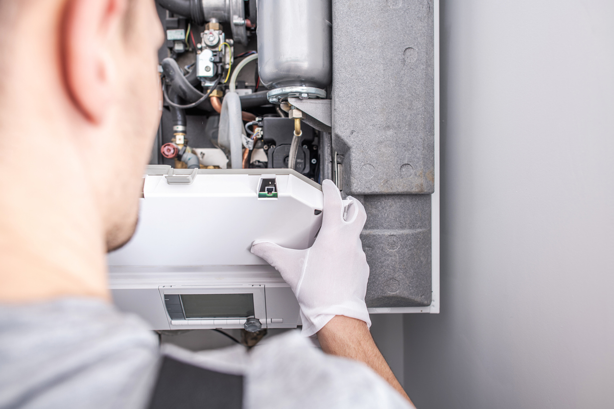 Close up of HVAC technician working on a furnace